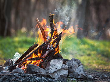 Stone bonfire pit with vibrant fire