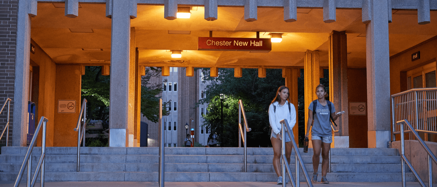 McMaster Humanities Students walks down steps from building