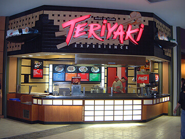 Restaurant front with grill-top and menu boards