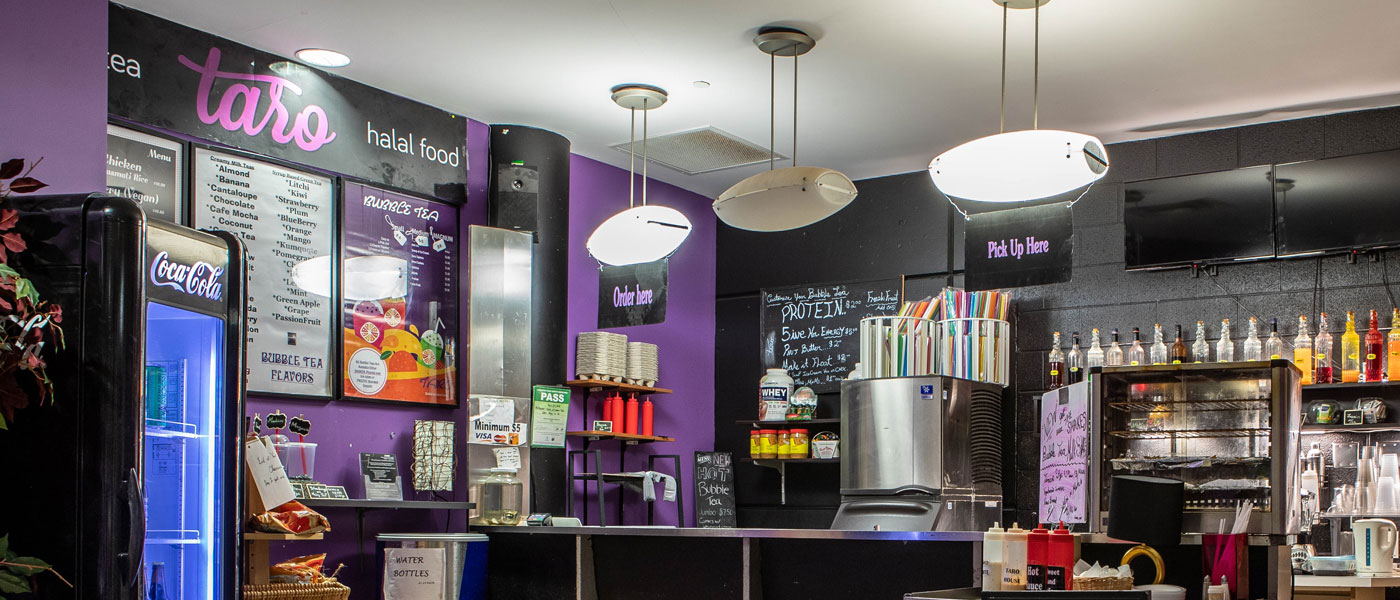 Small restaurant with purple walls serving halal food
